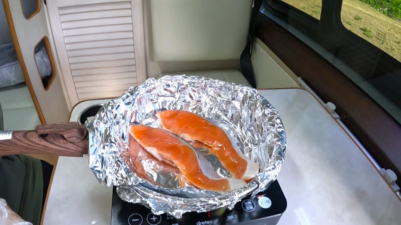フライパンの上で焼かれている鮭の切り身